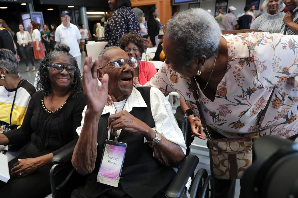 Edith Francisco, a fellow church member, greets World War II veteran Lawrence Brooks as he celebrates his 110th birthday at the National World War II Museum in New Orleans, Thursday, Sept. 12, 2019. Brooks was born Sept. 12, 1909, and served in the predominantly African-American 91st Engineer Battalion, which was stationed in New Guinea and then the Philippines during World War II. He was a servant to three white officers in his battalion. (AP Photo/Gerald Herbert)