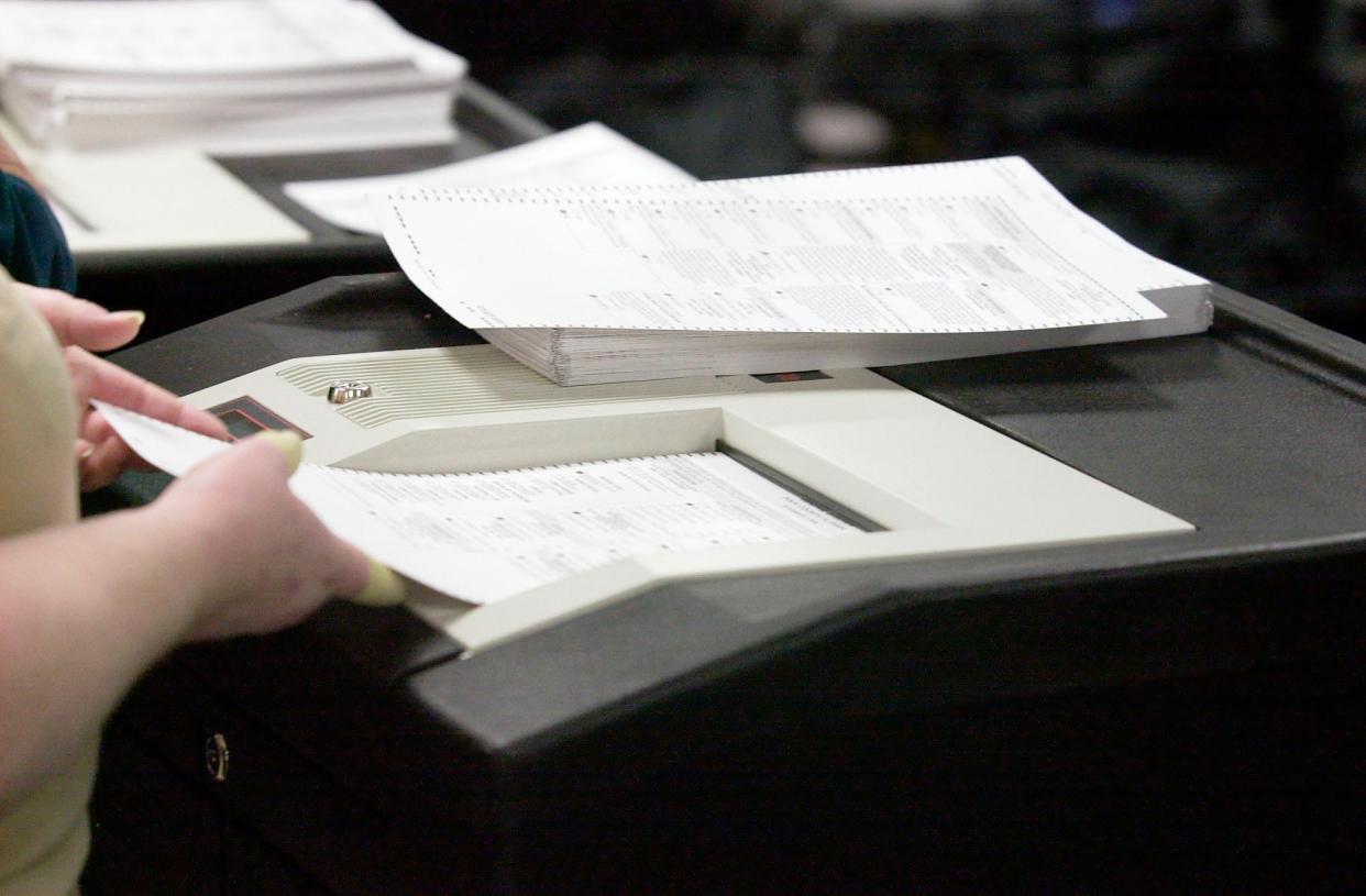 Ballots are hand loaded in to a vote counter in Polk County during the 2000 election. In that election, Florida was widely ridiculed for problems with results from counties that still used punch-card systems. Polk County was not one of those counties.