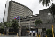 FILE - Security guards stand outside the Department of Foreign Affairs in Manila, Philippines on Friday, Jan. 29, 2021. State-sponsored Chinese hackers have been broadly targeting government and private sector organizations across Southeast Asia, including the Philippines Department of Foreign Affairs and the Armed Forces, according to a report released Wednesday by a U.S.-based private cybersecurity company. (AP Photo/Aaron Favila, File)