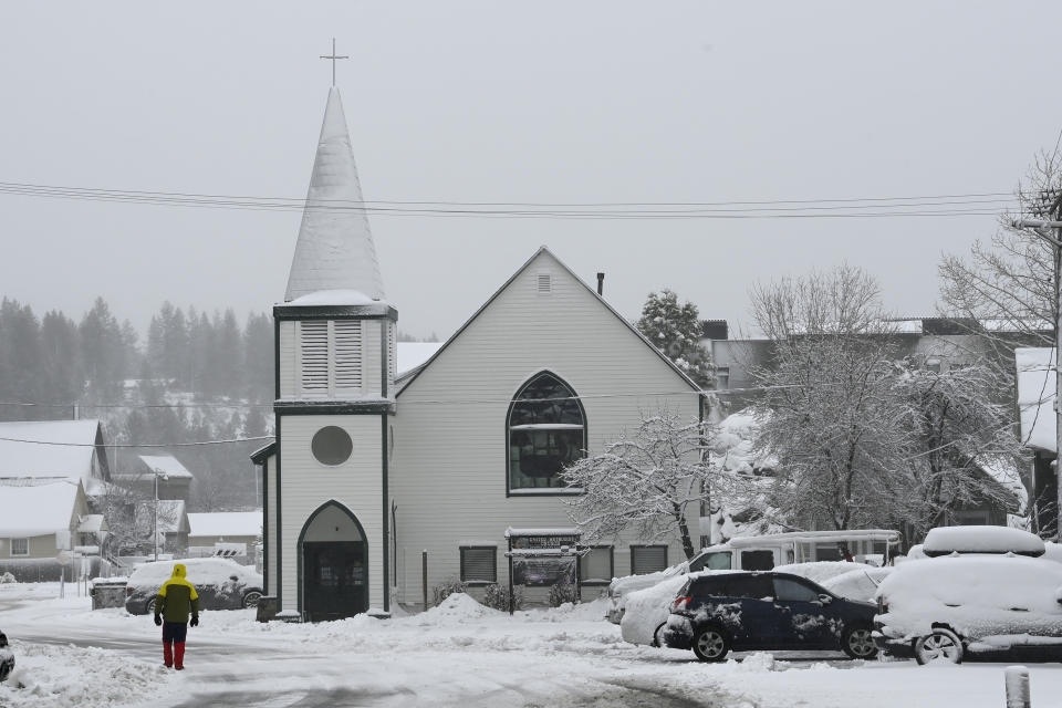 A person walks along a covered Jibboom Street on Friday, March 1, 2024, in Truckee, Calif. The most powerful Pacific storm of the season is forecast to bring up to 10 feet of snow into the Sierra Nevada by the weekend (AP Photo/Andy Barron)