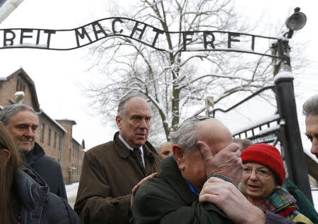 Mordechai Ronen (C right) of Canada, a survivor of the former German Nazi concentration and extermination camp Auschwitz reacts next to the World Jewish Congress President Ronald S. Lauder (2nd L) as they visit the camp in Oswiecim January 26, 2015. REUTERS/Laszlo Balogh