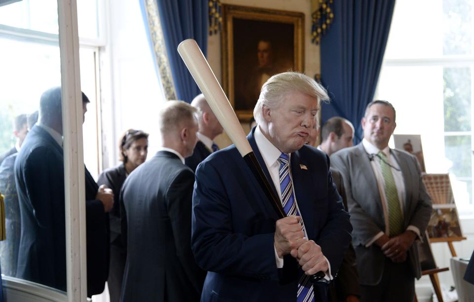 US President Donald Trump examines US-made products from all 50 states, including a Marucci baseball bat, in the Blue Room of the White House during a