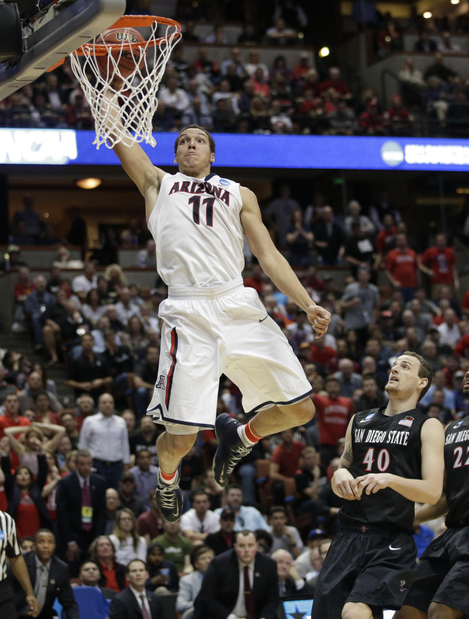 Arizona forward Aaron Gordon (11) dunks as San Diego State forward Matt Shrigley (40) watches during the second half in a regional semifinal of the NCAA men's college basketball tournament, Thursday, March 27, 2014, in Anaheim, Calif. (AP Photo/Jae C. Hong)