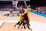 <p>Marques Townes #5 of the Loyola Ramblers drives to the basket against Ibi Watson #23 of the Michigan Wolverines in the 2018 NCAA Men’s Final Four semifinal game at the Alamodome on March 31, 2018 in San Antonio, Texas. (Photo by Jamie Schwaberow – Pool/Getty Images) </p>
