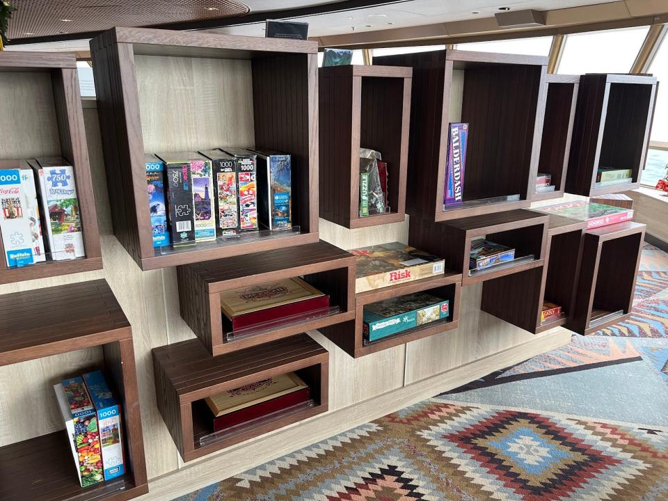 board games in a cubical shelf on a ship