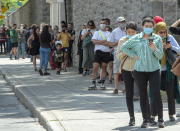 Hundreds of people lineup at the COVID-19 testing clinic Tuesday, July 14, 2020 in Montreal. The city has recommended that anyone who has been in a bar since July 1, 2020 to get tested. (Ryan Remiorz/The Canadian Press via AP)