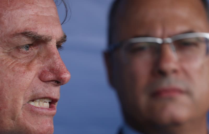 Brazilian President Jair Bolsonaro talks with media as Rio de Janeiro's Governor Wilson Witzel observes, after attending a ceremony to celebrate the Victory Day marking the Allied Forces' victory in World War Two in Rio de Janeiro