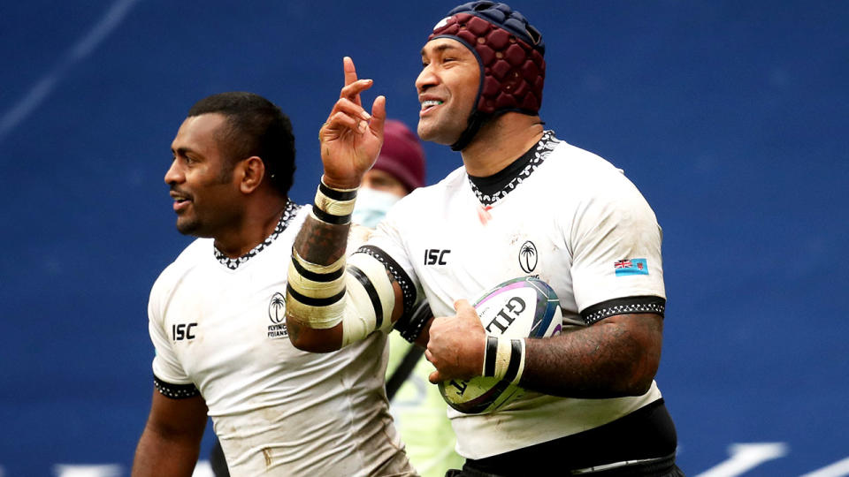 Fiji's Nemani Nadolo (pictured right) celebrates after scoring his side's fifth try.