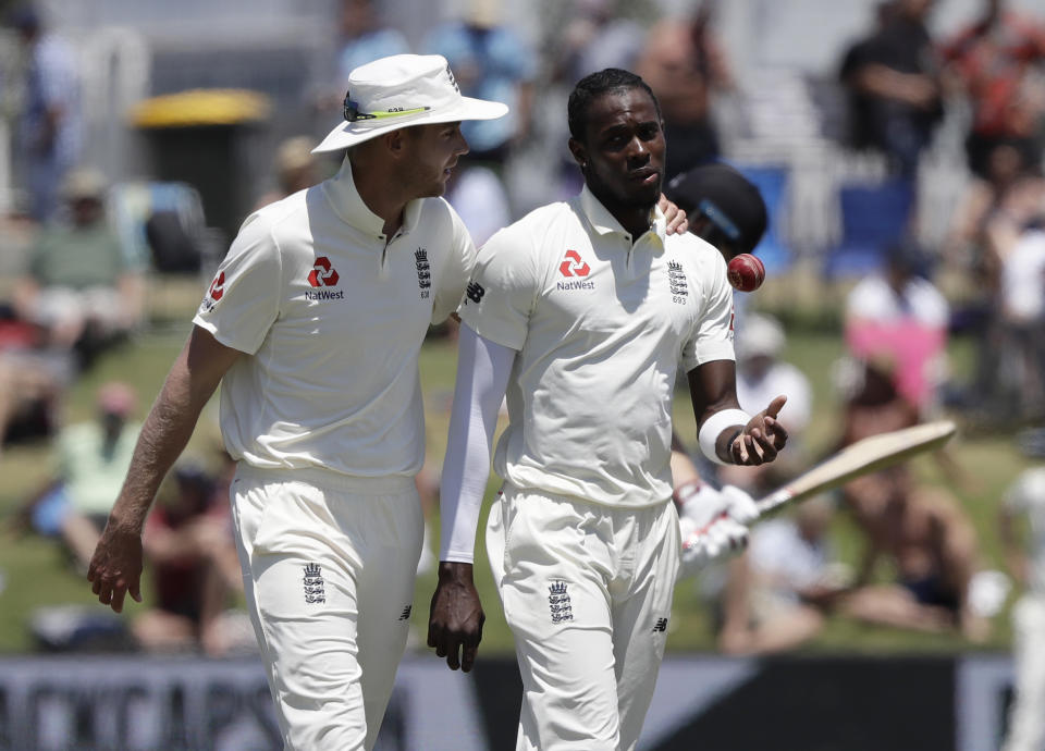 FILE- In this Nov. 24, 2019 file photo, England's Stuart Broad, left, chats with teammate Jofra Archer during play on day four of the first cricket test between England and New Zealand at Bay Oval in Mount Maunganui, New Zealand. A New Zealand fan who racially abused Archer during a test match at Bay Oval in November has been banned from domestic and international matches in New Zealand for two years. (AP Photo/Mark Baker)