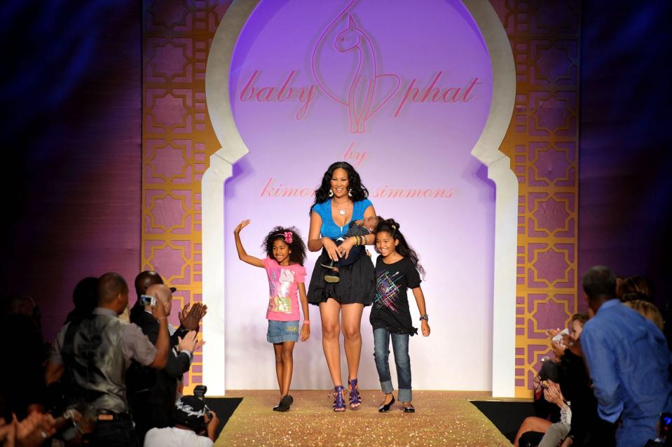 Designer Kimora Lee Simmons with children (L-R) Aoki Lee, Kenzo Lee Hounsou and Ming Lee on the runway at the Baby Phat & KLS Collection Spring 2010 fashion show at Roseland Ballroom on September 15, 2009 in New York, New York.