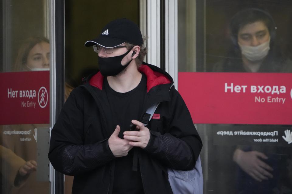 People wearing face masks to help curb the spread of the coronavirus leave a subway in Moscow, Russia, Friday, Oct. 15, 2021. Russia's daily tolls of coronavirus infections and deaths have surged to another record in a quickly mounting figure that has put a severe strain on the country's health care system. The record for daily COVID-19 deaths in Russia has been broken repeatedly over the past few weeks as fatalities steadily approach 1,000 in a single day. (AP Photo/Alexander Zemlianichenko)