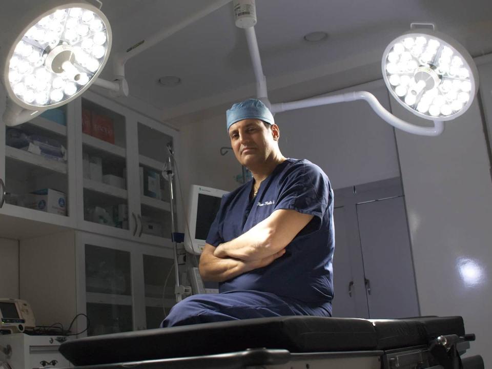 Plastic surgeon Dr. Norman Rowe sits in his New York City office.