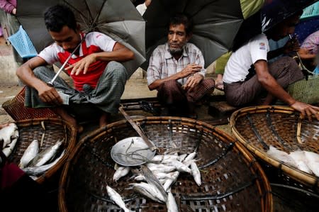 Muslim vendors sell fish in the market of Maungdaw