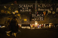 People gather for Kevin Peterson Jr., who was killed in Thursday's shooting with police involved, at a candlelight vigil in Vancouver, Wash., Friday, Oct. 30, 2020. The Clark County Sheriff's office has not released any details on the Thursday evening shooting in Hazel Dell, but a man told The Oregonian/OregonLive that his 21-year-old son was fatally shot by police. (AP Photo/Paula Bronstein)