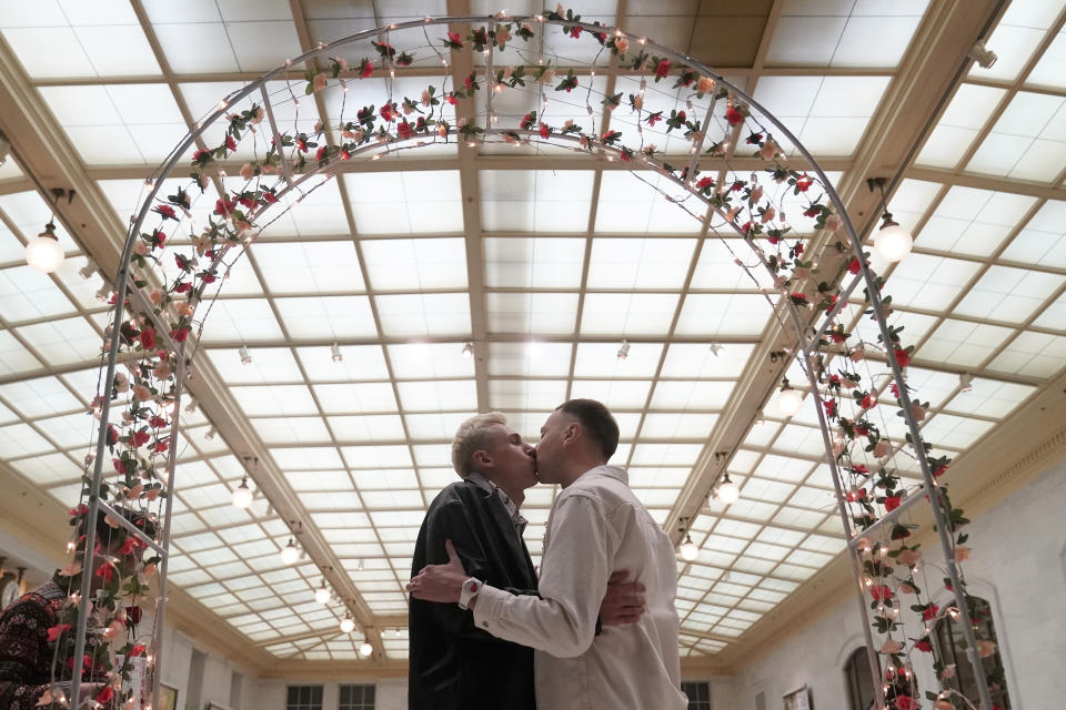 Iurii Sigarev, left, kisses Viktor Staroverov, both from Russia, while getting married at City Hall in San Francisco, Tuesday, Feb. 14, 2023. In a state known to set the pace for the rest of the country on progressive policies, and one where its governor made news by issuing marriage licenses to same-sex couples while serving as the mayor of San Francisco, California lawmakers will attempt to enshrine marriage equality into the state's constitution. The effort comes 15 years after a voter-approved initiative, called Proposition 8, temporarily banned the state from recognizing same-sex marriages. (AP Photo/Jeff Chiu)