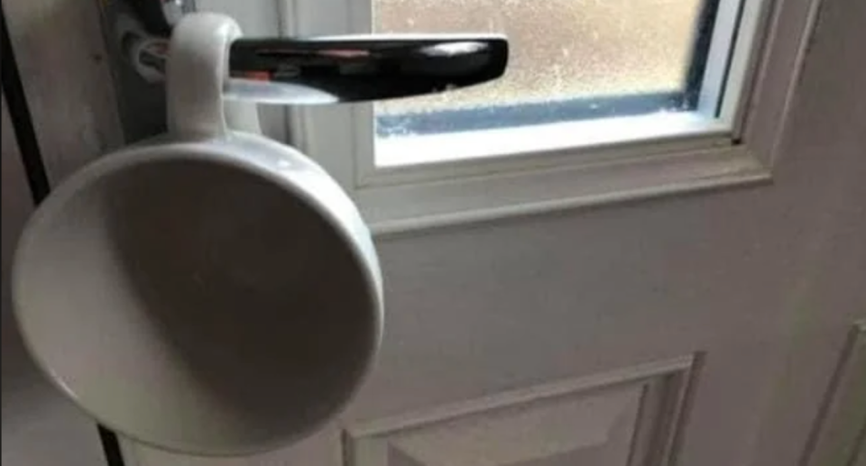 Cup on door handle of a home.