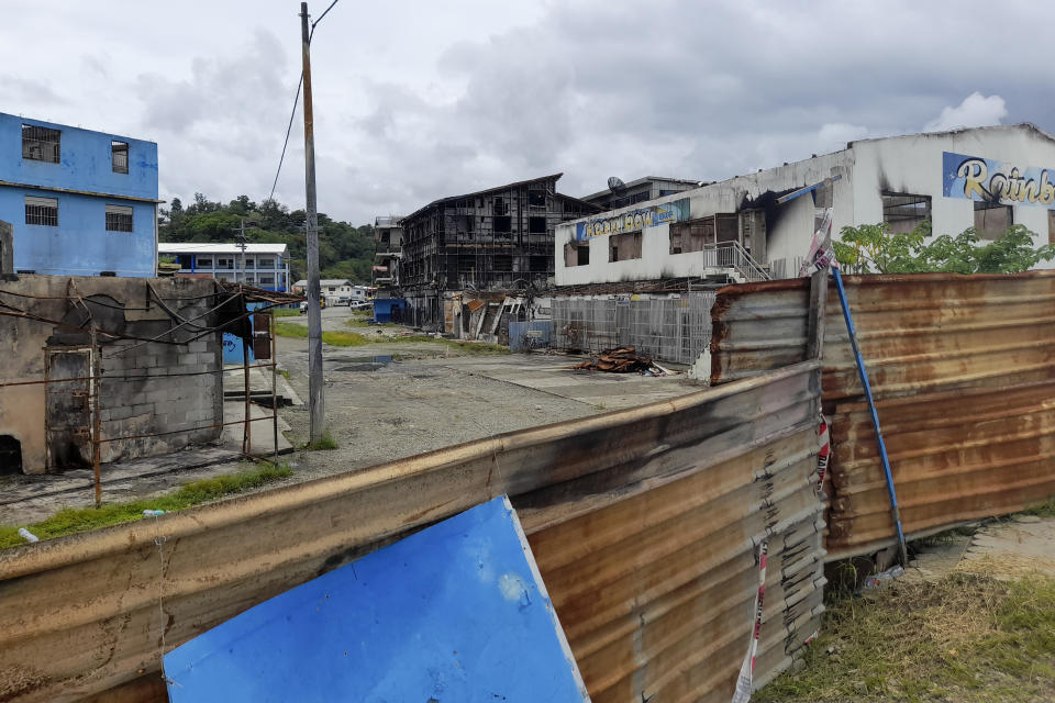 Damaged buildings from the November 2021 riots still stand in Honiara's Chinatown in the Solomon Islands, Friday, April 1, 2022. Seeking to counter international fears over its new security alliance with China, the Solomon Islands said Friday, April 1, 2022 it won't allow China to build a military base there. (AP Photo/Charley Piringi)