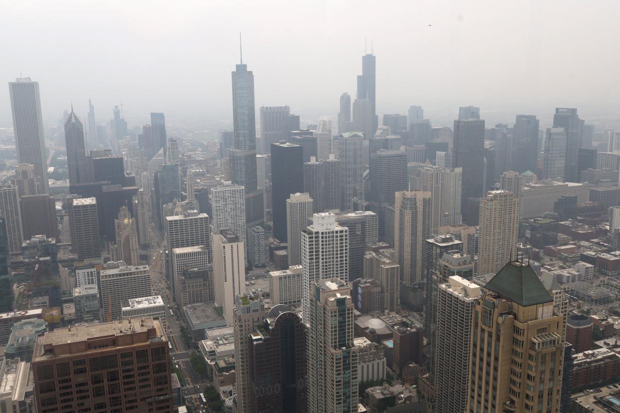 In this June 29, 2023, photo, wildfire smoke obscures the view from the former John Hancock Building in Chicago.