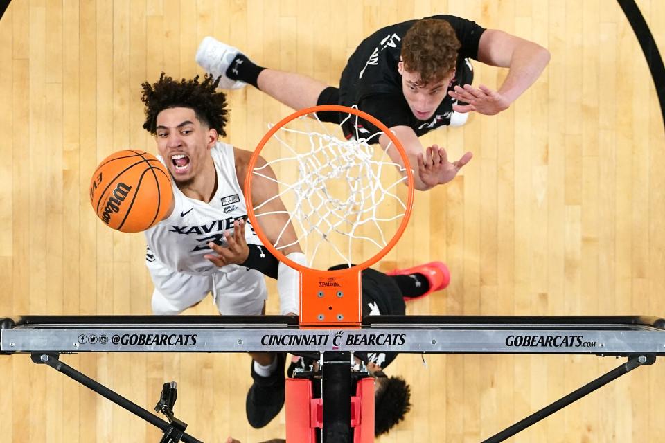 Xavier Musketeers guard Colby Jones (3) finishes at the basket in the first half of the 90th Crosstown Shootout college basketball game against the Cincinnati Bearcats, Saturday, Dec. 10, 2022, at Fifth Third Arena in Cincinnati. The Xavier Musketeers won, 80-77.