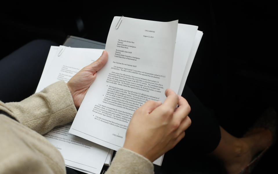 A member of the audience holds a copy of the Whistle-Blower Complaint letter sent to Senate and House Intelligence Committees during testimony by Acting Director of National Intelligence Joseph Maguire before the House Intelligence Committee on Capitol Hill in Washington, Thursday, Sept. 26, 2019. (AP Photo/Pablo Martinez Monsivais)