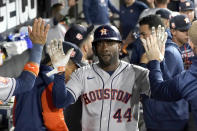 Houston Astros' Yordan Alvarez celebrates in the dugout after scoring on a sacrifice fly by Trey Mancini during the fourth inning of a baseball game against the Chicago White Sox Wednesday, Aug. 17, 2022, in Chicago. (AP Photo/Charles Rex Arbogast)