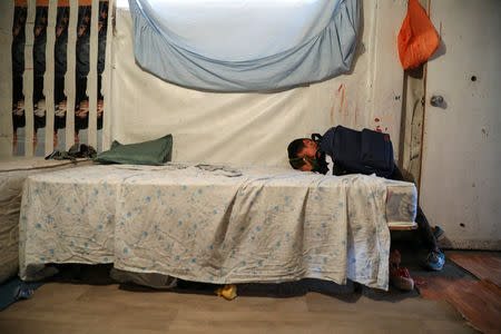 David Stan, 7, cries after having to give away his cat Coral before moving out of El Gallinero shanty town and into a new apartment in Madrid, Spain, September 26, 2018. REUTERS/Susana Vera