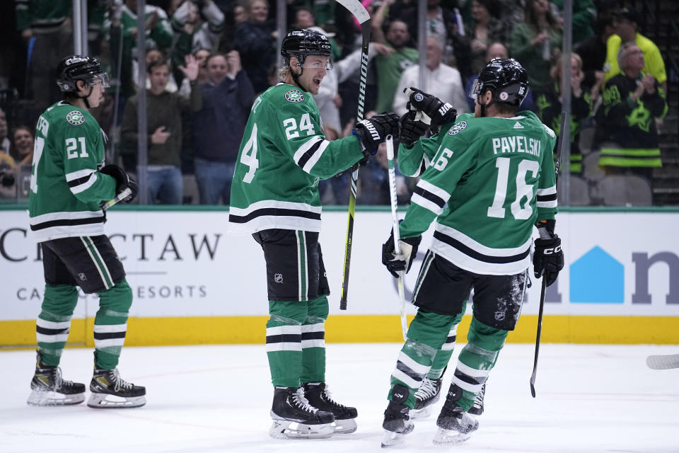 Dallas Stars' Roope Hintz (24), Joe Pavelski (16) and Jason Robertson (21) celebrate a goal scored by Hintz in the first period of an NHL hockey game against the Nashville Predators, Monday, April 3, 2023, in Dallas. (AP Photo/Tony Gutierrez)