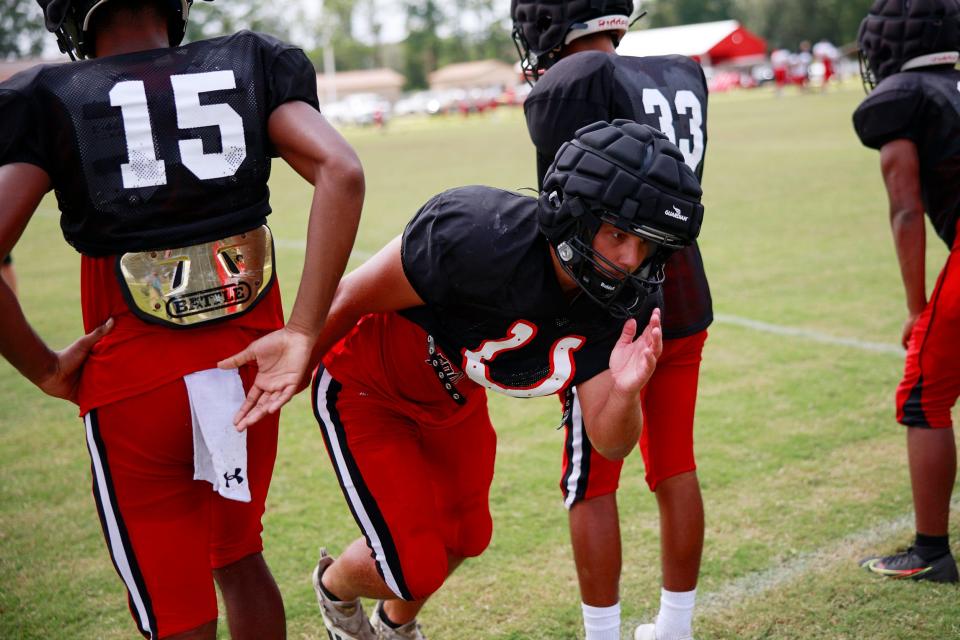 Middleburg linebacker Austin Cruce finds a lane through blockers in practice. The Broncos are in the regional playoffs for only the second time since 2003.