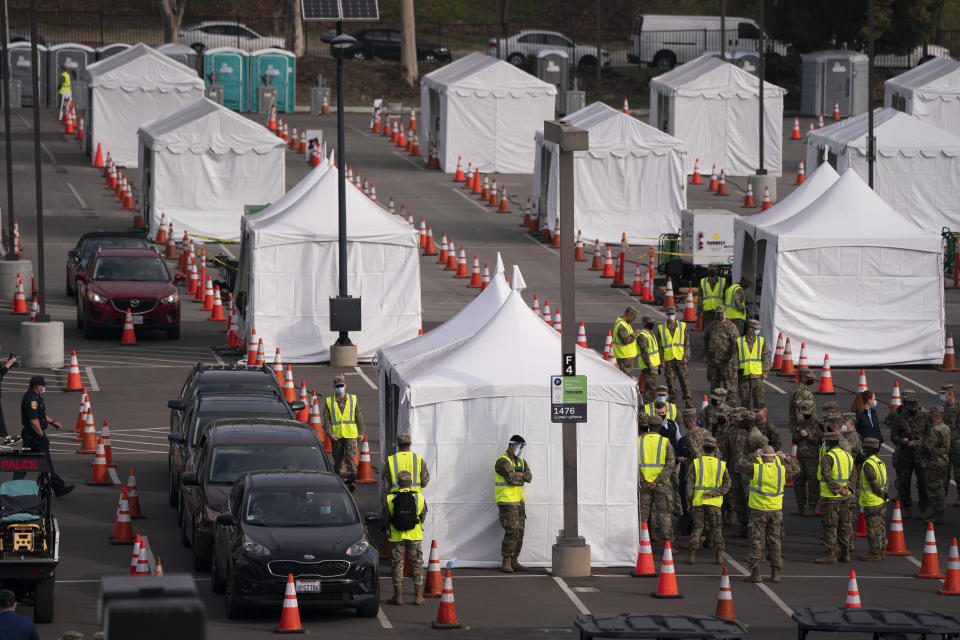 Motorists wait to get their COVID-19 vaccine at a federally-run vaccination site set up on the campus of California State University of Los Angeles in Los Angeles, Tuesday, Feb. 16, 2021. (AP Photo/Jae C. Hong)