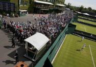Spectators arrive for the first day's play at the Wimbledon Tennis Championships in London, June 29, 2015. REUTERS/Stefan Wermuth