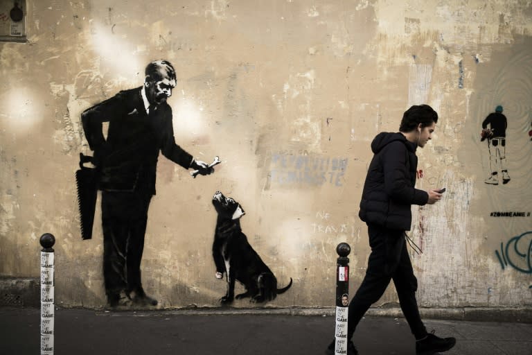 Anonymous street artist Banksy's artwork of a man holding a handsaw behind his back and offering a bone to a three-legged dog has been found near Sorbonne University, in the center of Paris over the weekend