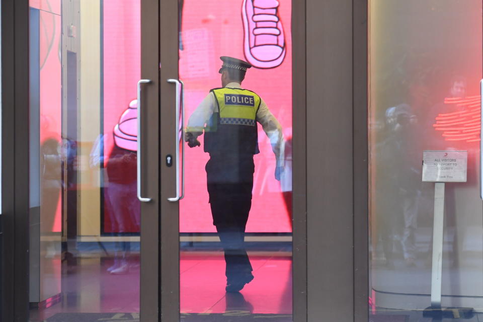 A police officer enters the Sony building in Kensington (PA Images)