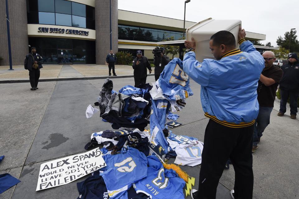 A former Chargers fan dumps memorabilia in front of of the San Diego Chargers headquarters after the team announced that it will move to Los Angeles, Thursday Jan. 12, 2017, in San Diego. (AP Photo/Denis Poroy)