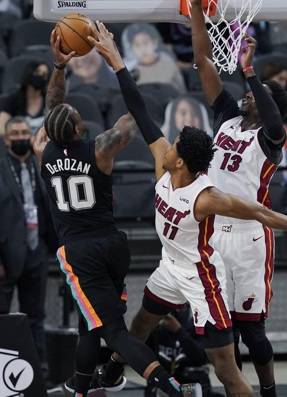 San Antonio Spurs forward DeMar DeRozan (10) is blocked by Miami Heat forward KZ Okpala (11) during the second half of an NBA basketball game in San Antonio, Wednesday, April 21, 2021. (AP Photo/Eric Gay)