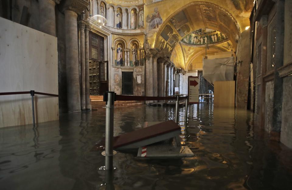 High water floods the inside of St. Mark's Basilica, in Venice, Wednesday, Nov. 13, 2019. The high-water mark hit 187 centimeters (74 inches) late Tuesday, Nov. 12, 2019, meaning more than 85% of the city was flooded. The highest level ever recorded was 194 centimeters (76 inches) during infamous flooding in 1966. (AP Photo/Luca Bruno)