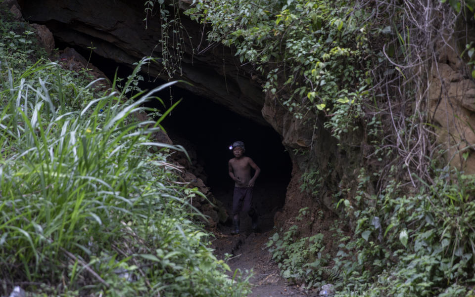 Andres Gomez, 11, exits the amber mine where he works near the community of Jotolchen II in Chiapas state, Mexico, Thursday, Sept. 10, 2020. Since the start of the new coronavirus pandemic lockdown, Andres works in the mine hoping to find a piece of amber for which a middleman might pay him $1 to $5, but what he really wants is “To learn to read and write,” he said. (AP Photo/Eduardo Verdugo)