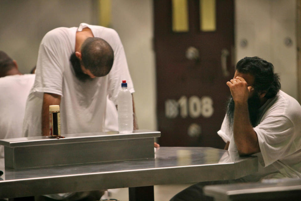 Detainees sit together inside the Camp 6 detention facility at Guantanamo Bay U.S. Naval Base in Cuba, May 31, 2009. The United States has made a new request for Australia to accept a group of detainees from Guantanamo Bay for resettlement, a government spokeswoman said on Saturday. The request is the first by President Barack Obama's administration, which plans to close down the detention camp in Cuba within the next year. (REUTERS/Brennan Linsley/Pool)