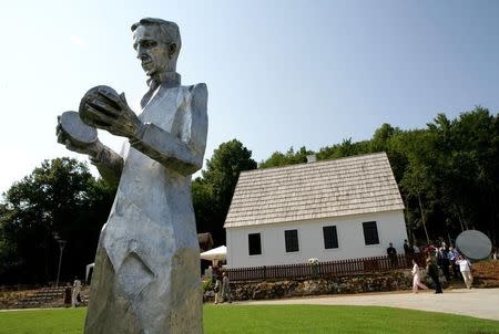 A monument of Croatian Serb scientist Nikola Tesla stands in front of his renovated house in Smiljan, central Croatia, July 10, 2006. REUTERS/Matko Biljak/File Photo