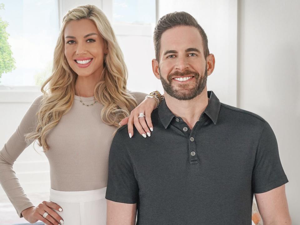 Heather Rae El Moussa and Tarek El Moussa pose for a photo.