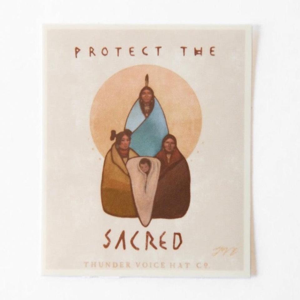 <p><a href="https://thundervoicehatco.com/products/defend-the-sacred-sticker" rel="nofollow noopener" target="_blank" data-ylk="slk:Shop Now;elm:context_link;itc:0;sec:content-canvas" class="link ">Shop Now</a></p><p>Protect the Sacred Sticker </p><p>thundervoicehatco.com</p><p>$5.00</p>