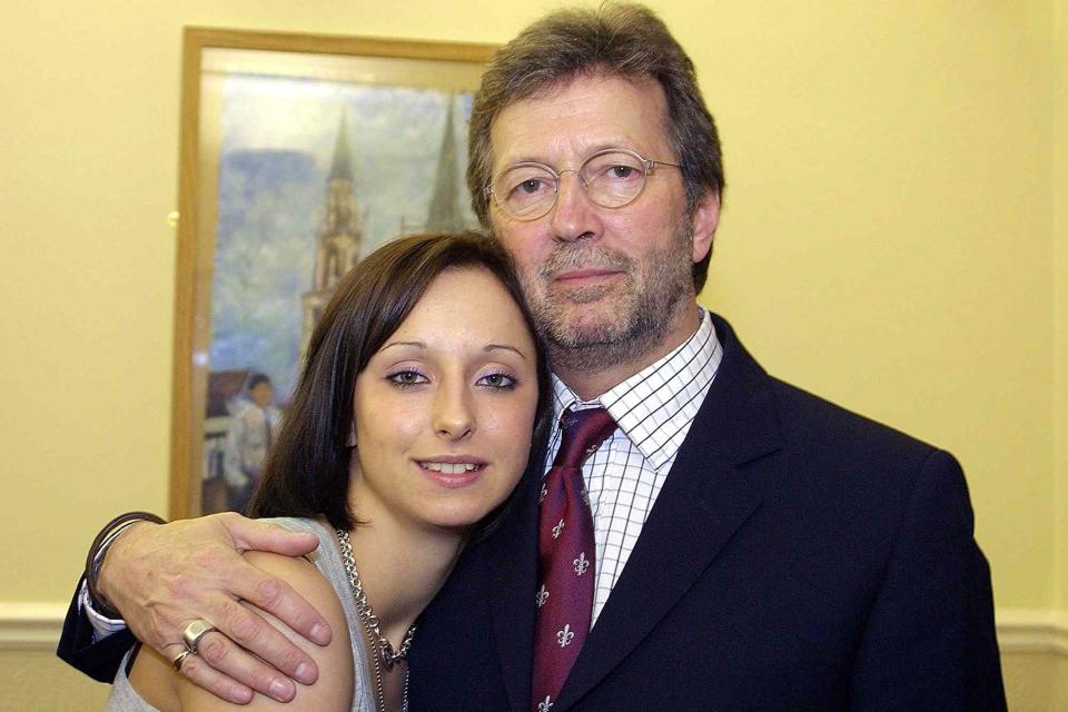 <p>Getty</p> Eric Clapton poses with his daughter Ruth before a performance in Birkdale school sports hall on March 18, 2003. 