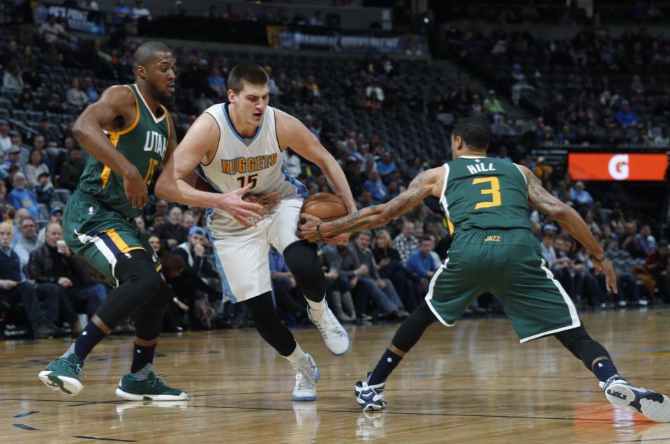 Derrick Favors (left) and George Hill (right) have both battled injury issues this season. (AP)