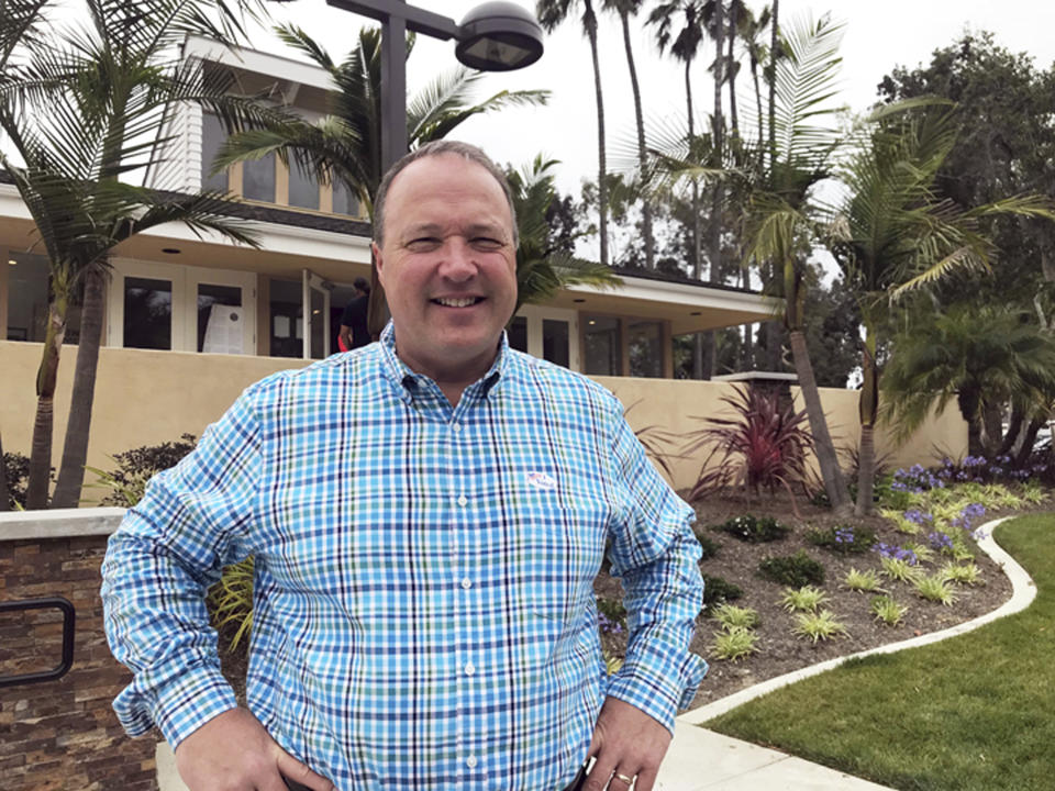 FILE - Scott Baugh, a Republican candidate for Congress from Orange County's 48th District, poses outside a polling place after voting in Huntington Beach, Calif., June 5, 2018. The Republican party also is hoping former state Assembly Republican leader Scott Baugh can upset Democratic Rep. Katie Porter in a costal district that includes famous surf breaks, including Huntington Beach. (AP Photo/Krysta Fauria, File)