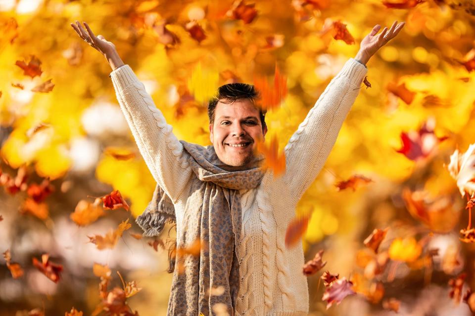 Luke Winkie during his Christian Girl Autumn fall leaf-peeping photoshoot in Vermont throwing leaves in the air. 