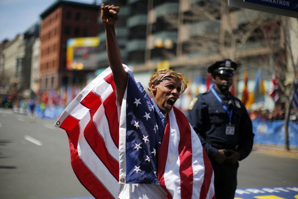 Meb Keflezighi of the U.S. reacts after winning the men's division of the 118th running of the Boston Marathon in Boston, Massachusetts April 21, 2014. Keflezighi on Monday became the first U.S. male athlete to win the Boston Marathon in three decades, an emotional performance in a city still recovering from last year's fatal bombing attack on the world-renowned race. REUTERS/Brian Snyder (UNITED STATES - Tags: SPORT ATHLETICS)