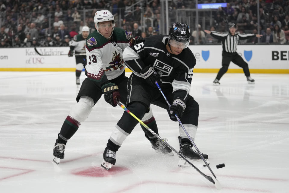 Arizona Coyotes defenseman Travis Dermott (33) defends against Los Angeles Kings center Quinton Byfield (55) during the second period of an NHL hockey game Tuesday, Oct. 24, 2023, in Los Angeles. (AP Photo/Ashley Landis)