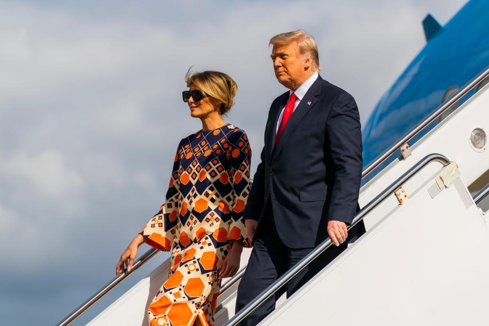 Former President Donald Trump and first lady Melania Trump disembark from their final flight on Air Force One in West Palm Beach, Florida, on Jan. 20, 2021.