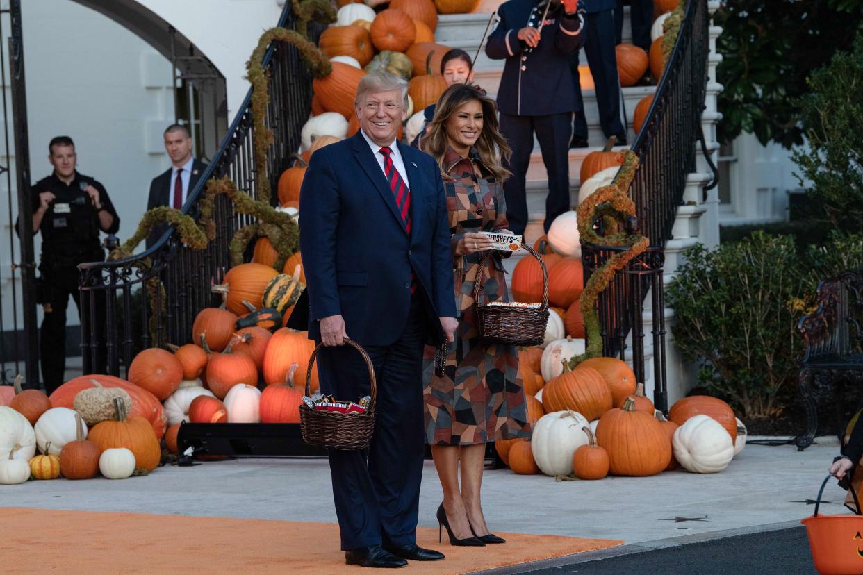 President Donald Trump and First Lady Melania Trump arrive to hand out candy for children at a Halloween celebration at the White House in Washington, D.C. (Photo: Nicholas Kamm via Getty Images)