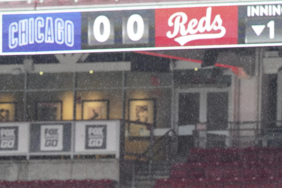 Rain falls during a rain delay prior to a baseball game between the Cincinnati Reds and the Chicago Cubs at Great American Ballpark in Cincinnati, Thursday, July 30, 2020. (AP Photo/Bryan Woolston)