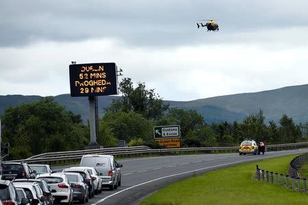 FILE PHOTO: A sign for customs and excise is seen on the motorway approaching the border between Northern Ireland and Ireland, near Newry, Northern Ireland July 13, 2017. REUTERS/Clodagh Kilcoyne/File Photo